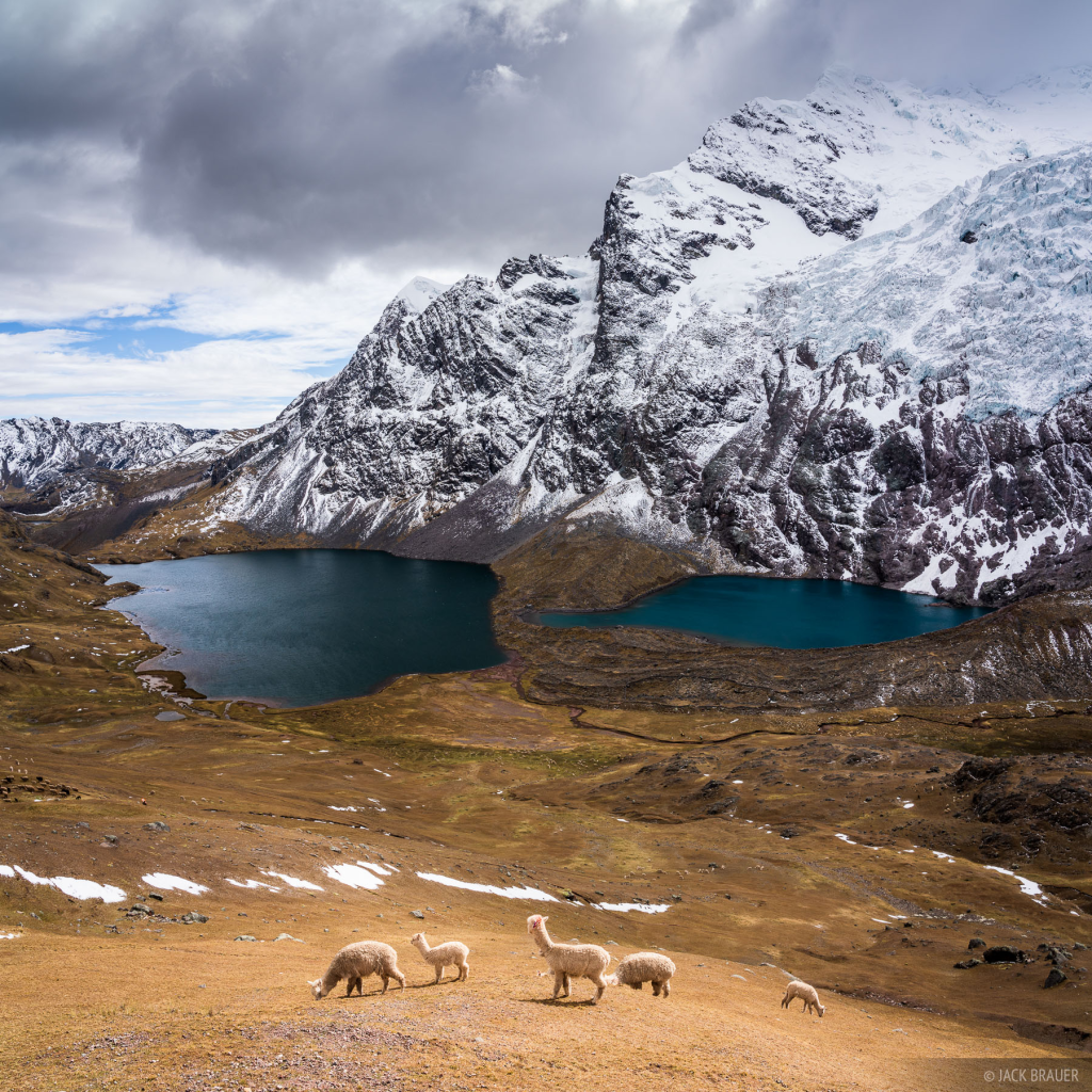 A stunning view of Pucacocha Lake, one of the 7 Lakes of Ausangate, nestled in the mountains.