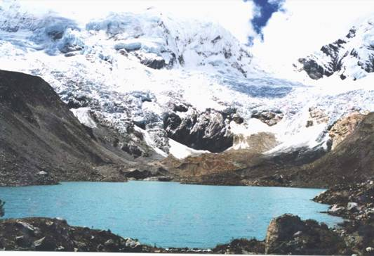 The serene Alqacocha Lake with the towering Ausangate Mountain Peru in the background